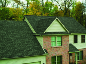 Aerial view of luxurious home with new asphalt shingle roofing from Owens Corning.