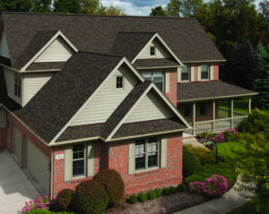 Exterior of a single family home with elaborate landscaping and gray roofing shingles