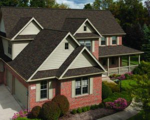 Roof Replacement Ballantyne NC Exterior of a single family home with elaborate landscaping and gray roofing shingles