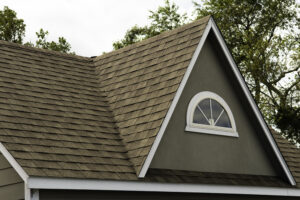 Close-up of a two-story home with green asphalt shingles roofing construction