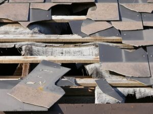 Broken pieces of damaged slates on a roof of a house.